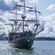 Passengers looking out to sea while sailing on a tall ship